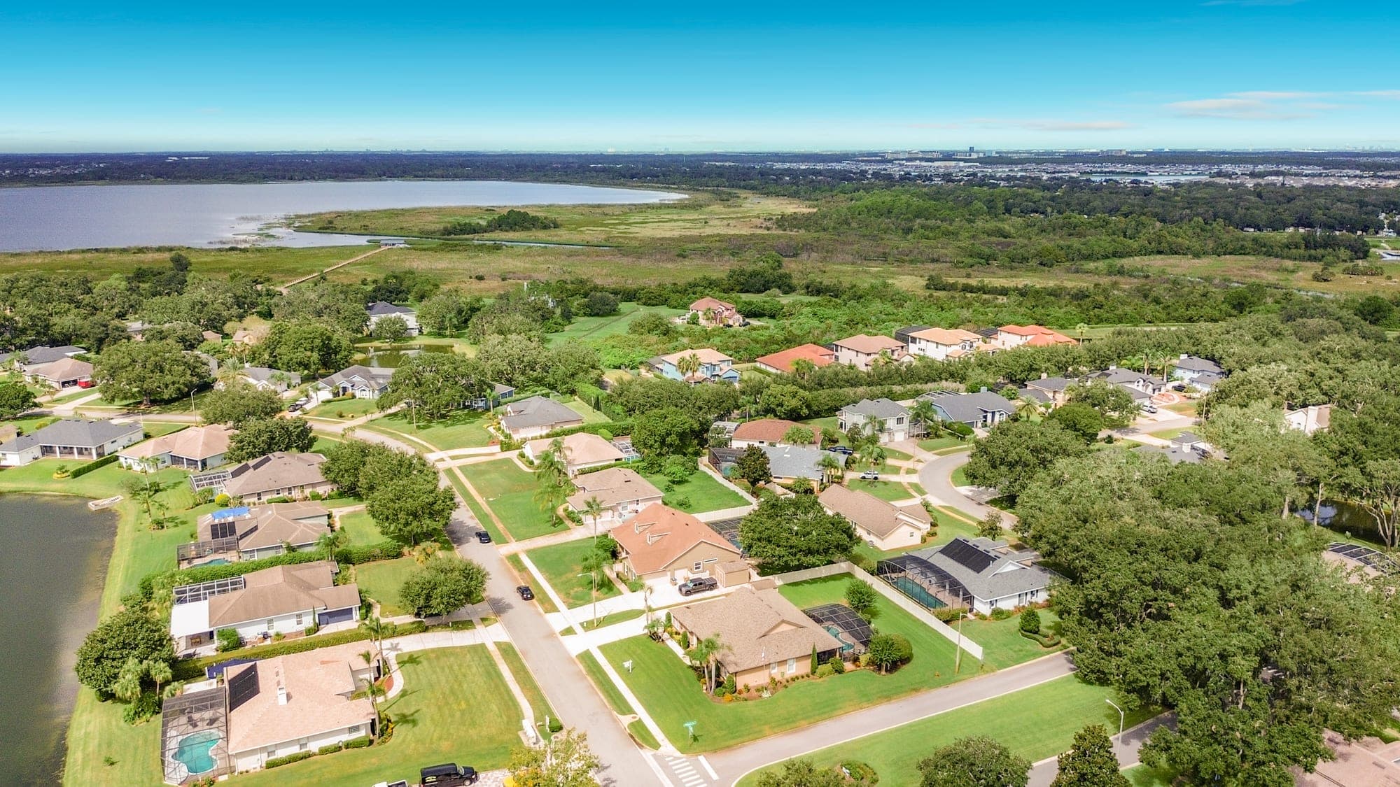 Aerial view of the Hammock Pointe neighborhood in St. Cloud, with mature oaks and the lake beyond