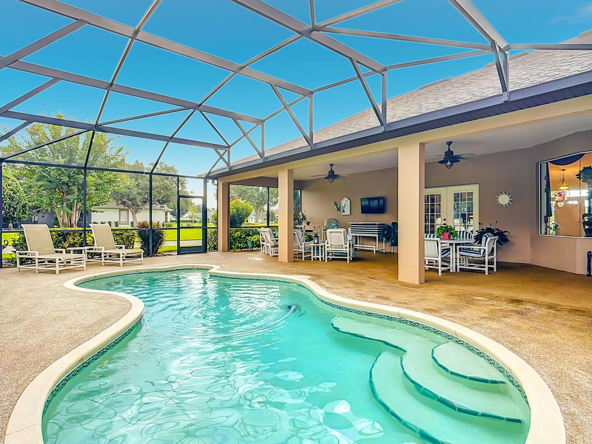 Screened pool and covered lanai with ceiling fans at 5243 Hammock Pointe Ct