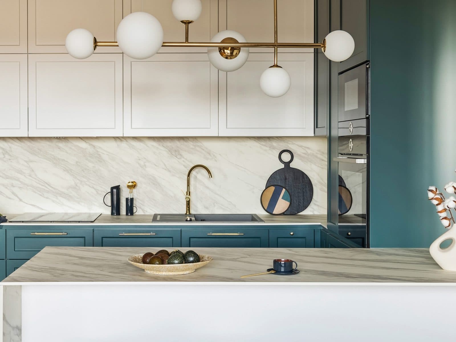 Staged kitchen with marble countertops and island, morning light